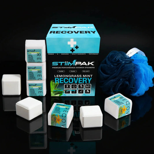 STIMPAK Recovery shower steamers with packaging on a reflective black surface