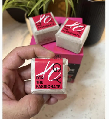 Hand holding STiiMPAK synergy shower steamers with box in the background