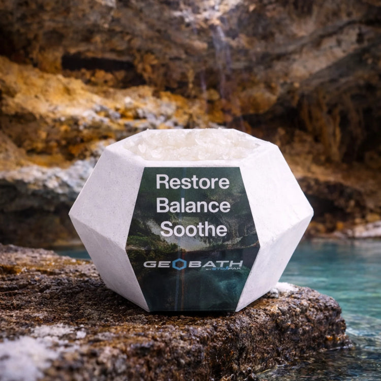 Geobath Bath Bomb Geode with 'Restore Balance Soothe' text and GeoBath logo on a rocky background