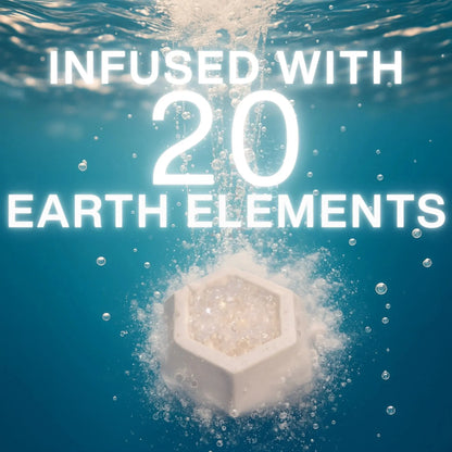 Geobath Geode Bath Bomb in water with text 'Infused with 20 Earth Elements' on a blue underwater background