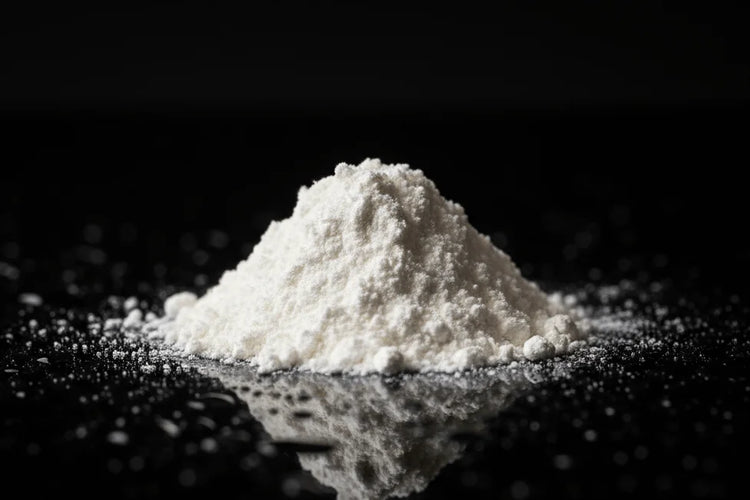 White L-theanine powder on a black background