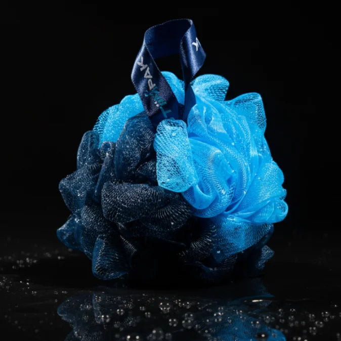 Blue and black bath pouf on a black background