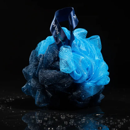 Blue and black bath pouf on a black background