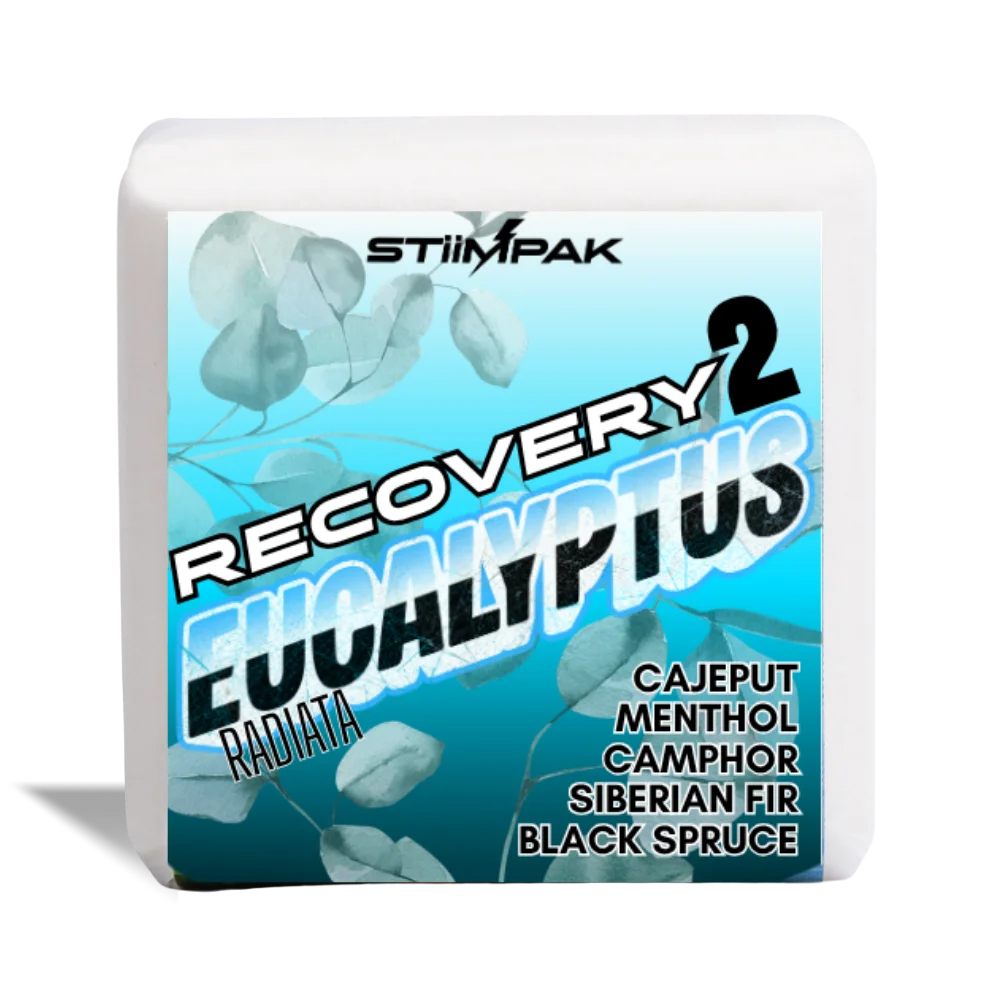 A white shower steamer, featuring a blue and teal label for STiiMPAK Recovery 2 Eucalyptus Radiata. The label includes eucalyptus leaf graphics and text listing ingredients: Cajeput, Menthol, Camphor, Siberian Fir, and Black Spruce.