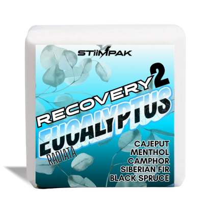 A white shower steamer, featuring a blue and teal label for STiiMPAK Recovery 2 Eucalyptus Radiata. The label includes eucalyptus leaf graphics and text listing ingredients: Cajeput, Menthol, Camphor, Siberian Fir, and Black Spruce.