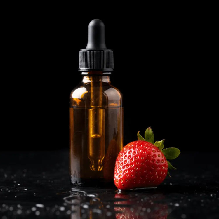 Amber glass dropper bottle with a black cap next to a red strawberry on a reflective black surface.