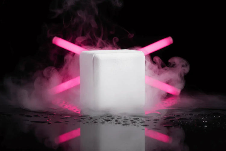 White shower steamer with pink glow stickers crossed behind it in steam