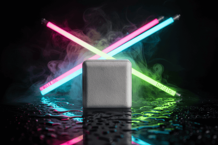 Neon light sticks emitting smoke on a dark surface