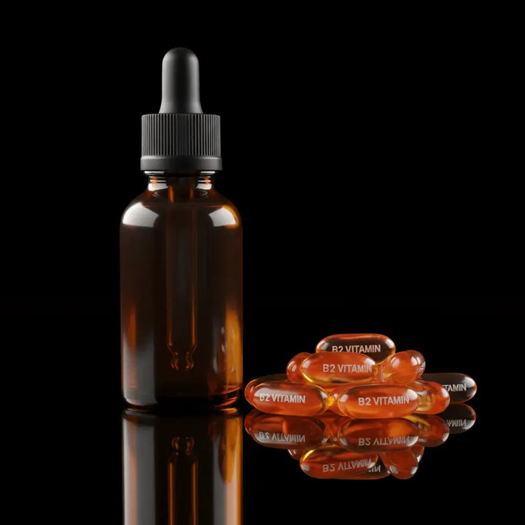 Brown glass dropper bottle with black cap on a reflective surface against a black background